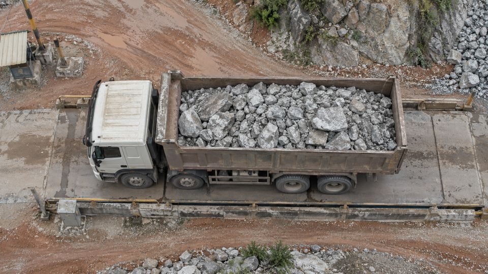 Dump truck loaded with rock parked on the tipping pad